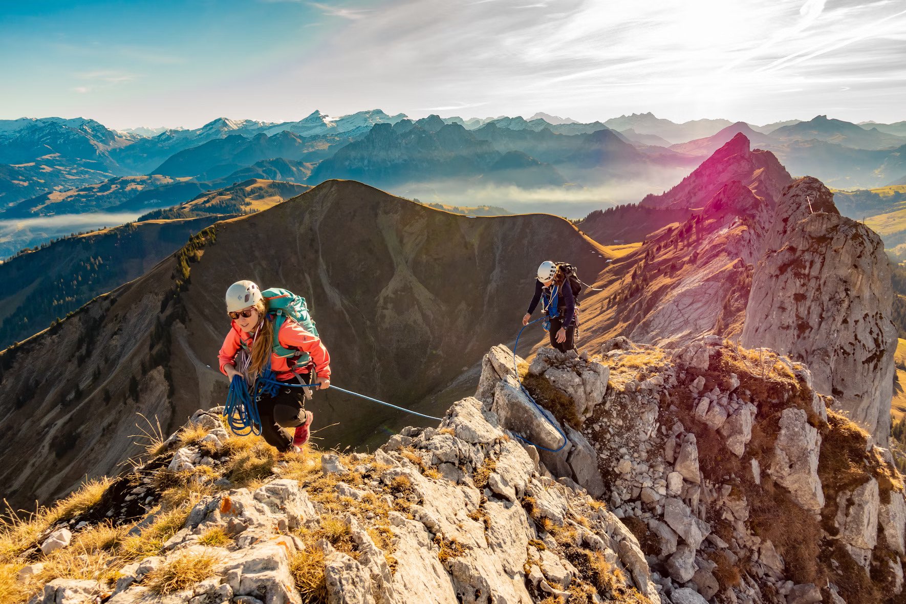 Photo of two climbers roped together traversing a ridge