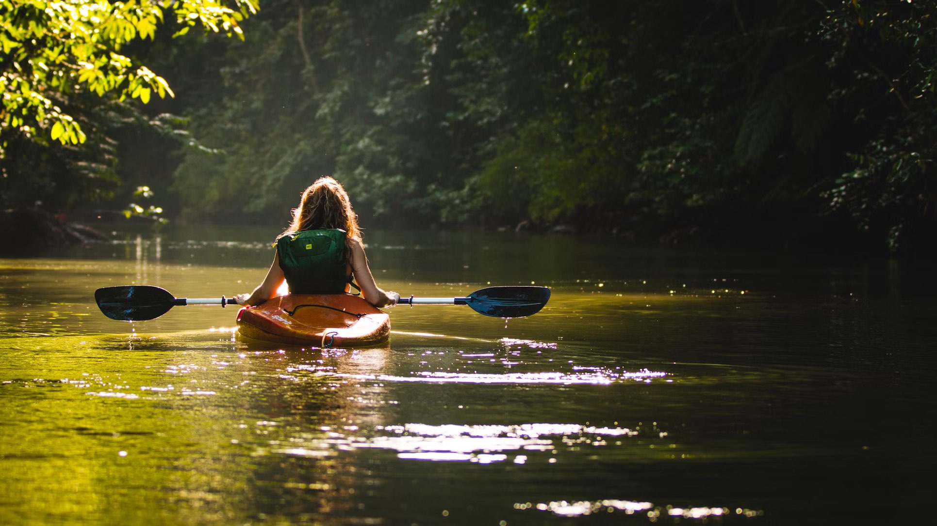 Photo of peaceful scene of lone kayaker on the loch